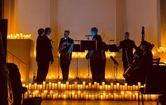 The Bristol Ensemble performing at The Mission Theatre in candlelight.