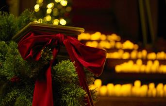A staircase of candles and a red bow
