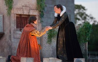 Outdoor theatre show with two actors on stage