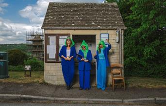 three women stood outside a bus stop