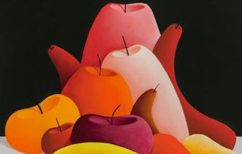 Red, pink, orange and yellow fruit on a grey and black background