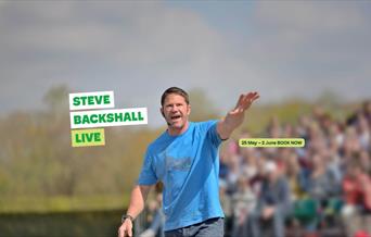 Steve Backshall presenting in front of an audience