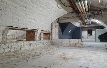 Original stone floors and vaulted ceilings in the basement at Bath Assembly Rooms