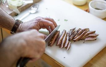person cutting meat