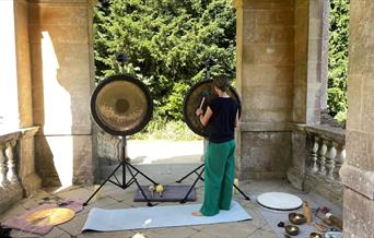 a woman banging a gong
