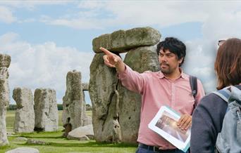 Jules presenting to his tour group in front of Stonehenge