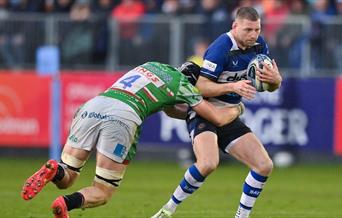 a man playing rugby being tackled
