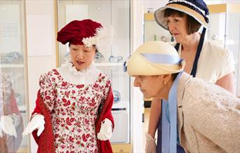 3 ladies dressed in regency wear