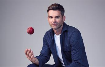 Jimmy Anderson throwing a cricket ball in the air