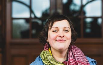 Headshot of Josie Long smiling to camera.