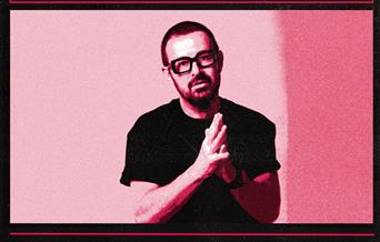 A photo in red tones of DJ Judge Jules