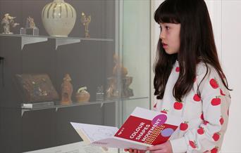 A young girl browsing one of the exhibits at the Museum of East Asian Art