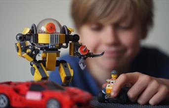 boy playing with lego