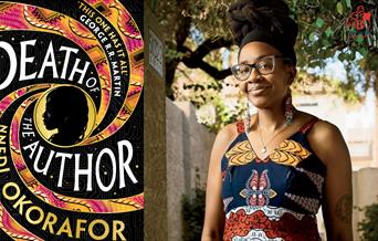 Nnedi Okorafor next to the cover of her book.