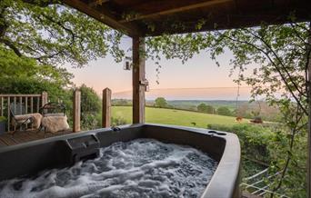 View of the fields from the hot tub on the porch of the treehouse