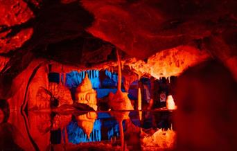 Cheddar Caves lit up in red and blue
