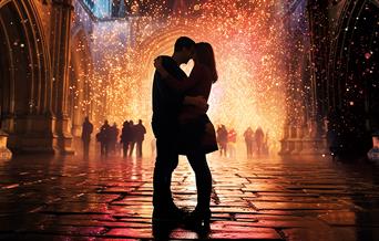 Poster image showing Romeo and Juliet silhouetted against a background of fireworks