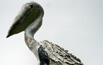 A sculpture of a pelican in clay
