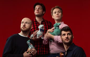 Shoot from the hip members pose with dog ornaments