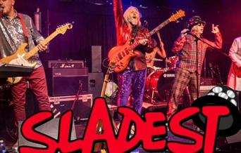 A photo of the band Sladest siing live on stage