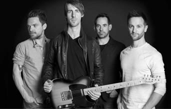 A black and white photo of the band.
