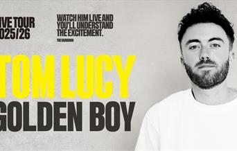 A poster advertising the show 'Tom Lucy: Golden Boy' at Komedia Bath