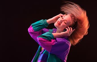 A women dancing with headphones