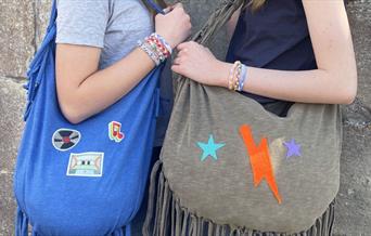 image of 2 teenagers holding upcycled bags