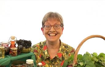 Helen Wood sits behind various foraged items