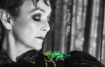 Woman with chameleon on shoulder