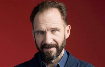 Head shot of man in front of red background