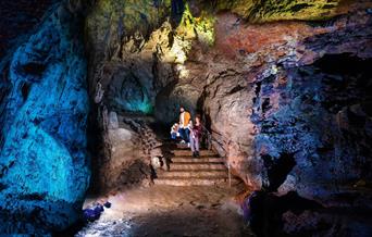 Family in illuminated cave at Wookey Hole Caves