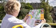 Woman looking at map on bus