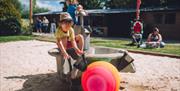 A boy digging in a sandpit