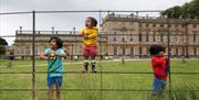 Children playing in front of a historic house