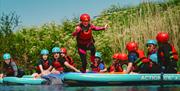 Children on a large inflatable SUP at Mendip Basecamp