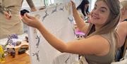 women holding tea towel