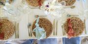 A table laid with place mats and glasses.