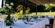 Outdoor covered seating, laid and decorated table