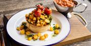 Brunch pie topped with potatoes and vine tomatos