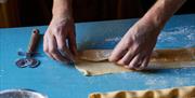 Hands making pasta