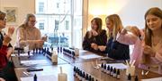 A group of women stood around a table at a perfume making workshop