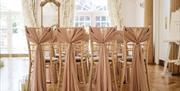 Decorated wedding hall, table and chairs.