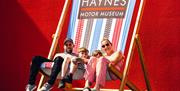 Family sitting on large deckchair at Haynes International Motor Museum