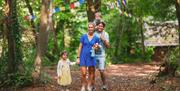 Family in the woodlands at Mendip Basecamp