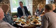 Group of diners enjoying Sunday roast