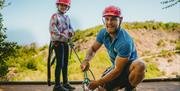 Child and instructor rope climbing