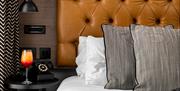 Close up of bed with drink on side table