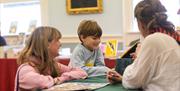 2 children enjoying looking at books