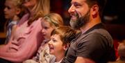 2 children enjoying a stage performance